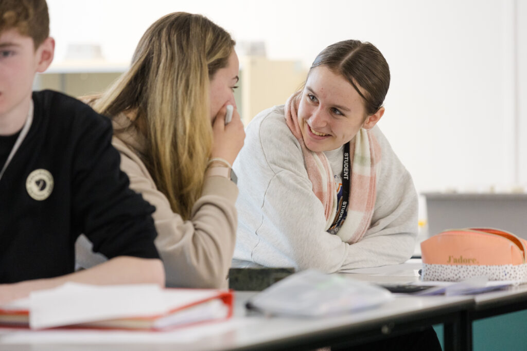 Students laughing at desks